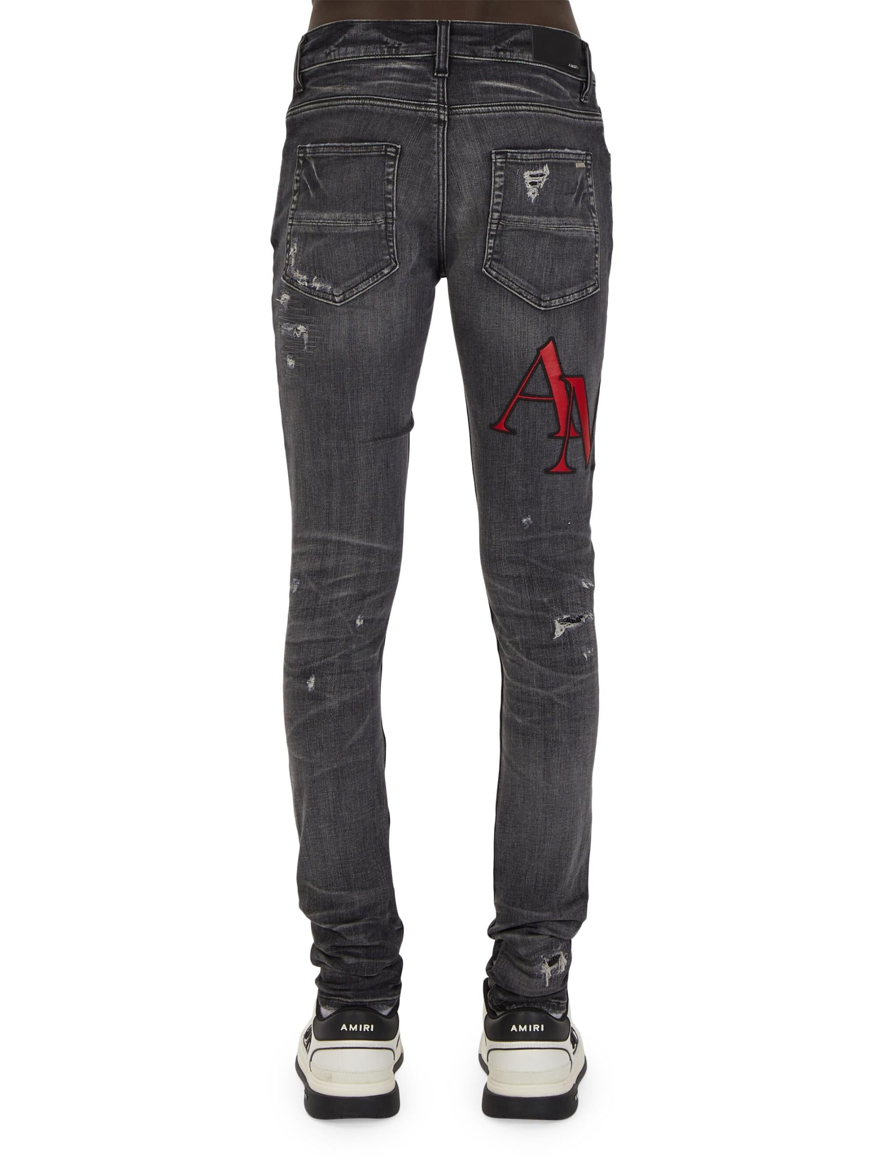 AMIRI STAGGERED LOGO JEANS-BLACK