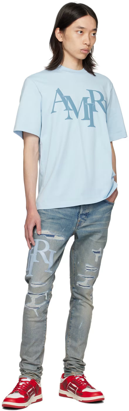 AMIRI STAGERED LOGO JEANS-blue